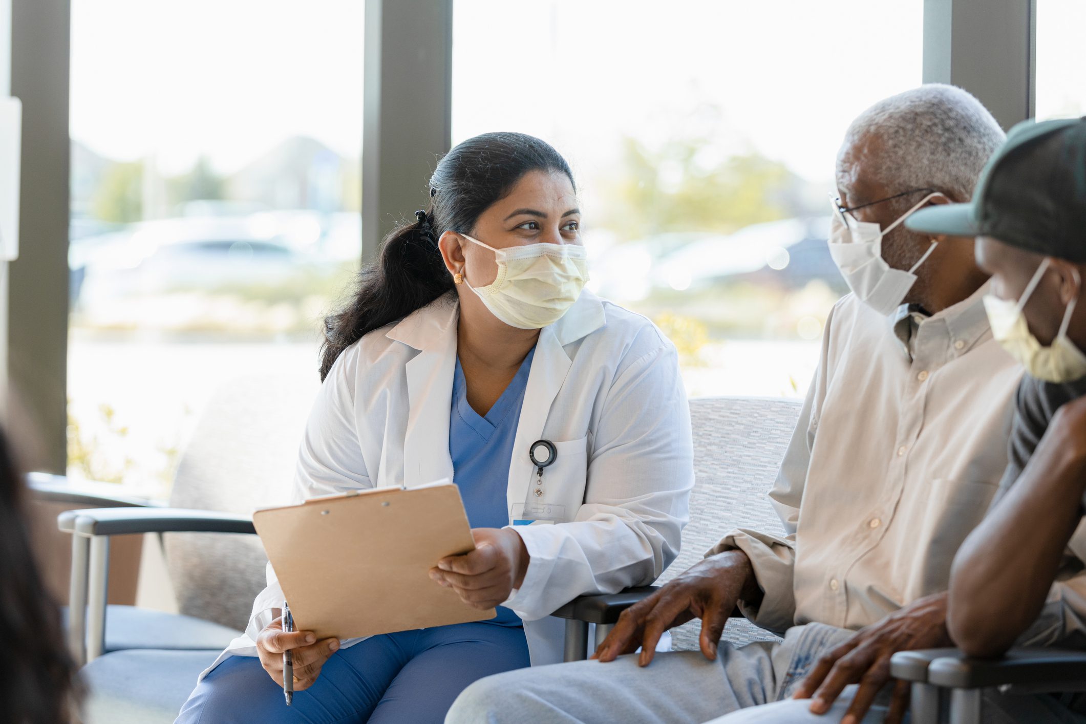 Female Doctor Talks To The Male Senior Adult Patient